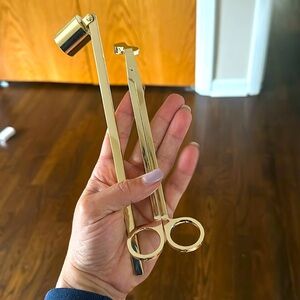 Gold candle wick cutter and flame puff.